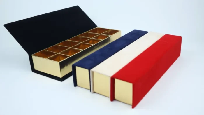 a box with a lid open and a red white and blue box with a red white and blue box with a gold lid