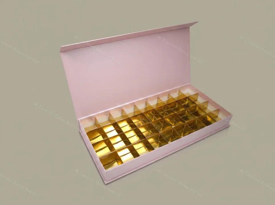 Pale pink chocolate box with gold compartment tray